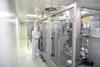 medical products manufacturing in a modern factory - worker operates modern industrial plant