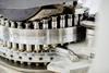 Background shot of punch tools in tablet press machine compressing powder into pills at pharmaceutical manufacturing plant