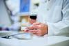 pharmacist-holding-medication-box-scanning-barcode