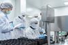 team-workers-protective-gear-inspecting-pharmaceutical