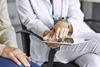 female-doctor-talking-patient-on-tablet