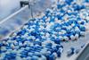 Blue,Capsules,Are,Moving,On,Conveyor,At,Modern,Pharmaceutical,Factory.