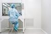 microbiologist-testing-sample-under-laminar-hood