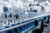 Sterile pharmaceutical assembly line with transparent vials moving in precision, clean manufacturing zone ensures regulated drug processing and quality control