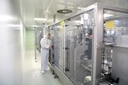 medical products manufacturing in a modern factory - worker operates modern industrial plant