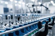 Sterile pharmaceutical assembly line with transparent vials moving in precision, clean manufacturing zone ensures regulated drug processing and quality control
