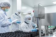team-workers-protective-gear-inspecting-pharmaceutical