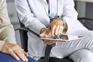 female-doctor-talking-patient-on-tablet