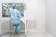 microbiologist-testing-sample-under-laminar-hood