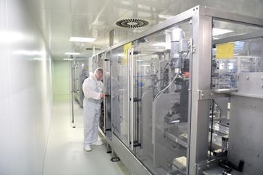 medical products manufacturing in a modern factory - worker operates modern industrial plant