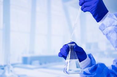 A,Scientist,Is,Holding,A,Beaker,Filled,With,Water.,Concept