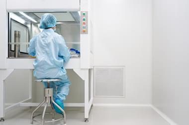 microbiologist-testing-sample-under-laminar-hood