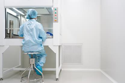 microbiologist-testing-sample-under-laminar-hood