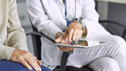 female-doctor-talking-patient-on-tablet