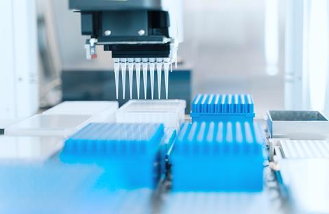 Automated liquid handling system dispensing samples into microplates for high-throughput laboratory testing