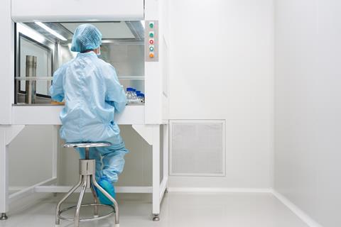 microbiologist-testing-sample-under-laminar-hood